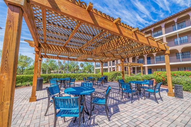 view of patio featuring a balcony and a pergola