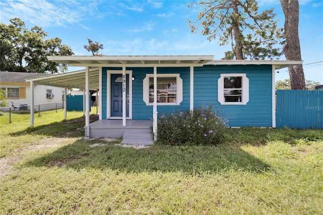 view of front of property with a carport and a front yard