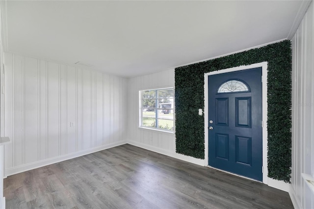 entrance foyer with hardwood / wood-style floors and crown molding