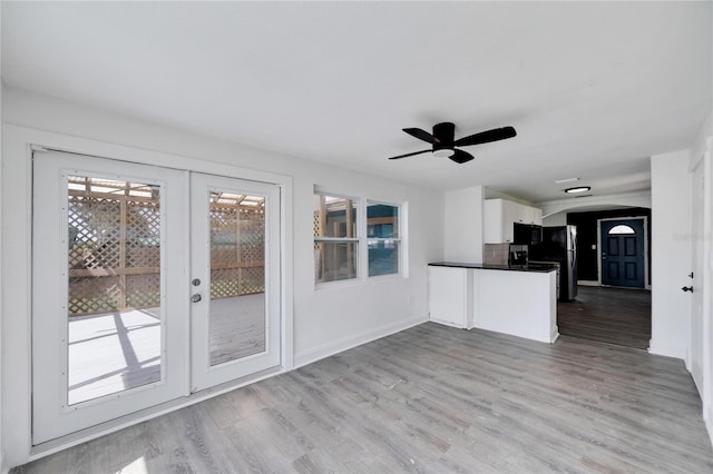 kitchen featuring french doors, kitchen peninsula, white cabinets, light hardwood / wood-style floors, and ceiling fan