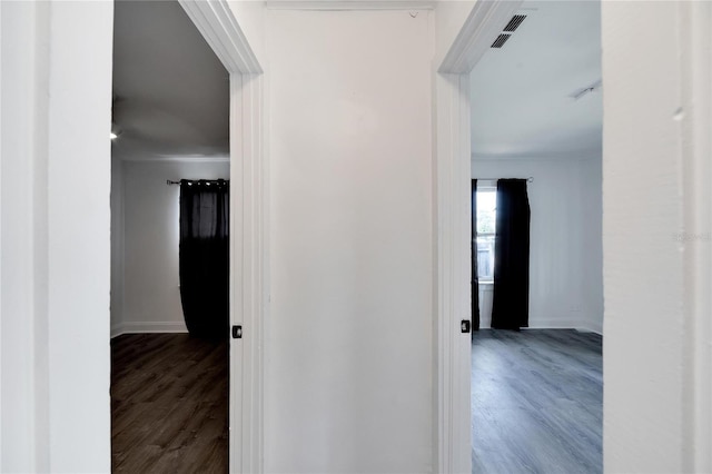 hallway with hardwood / wood-style floors