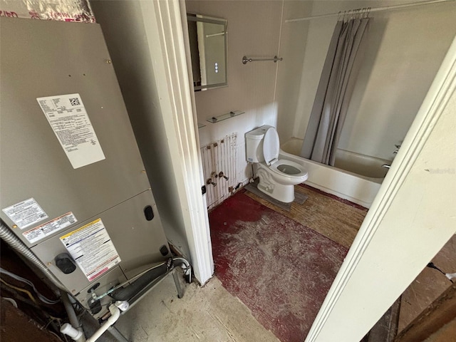 bathroom with concrete floors, shower / bath combination with curtain, heating unit, and toilet