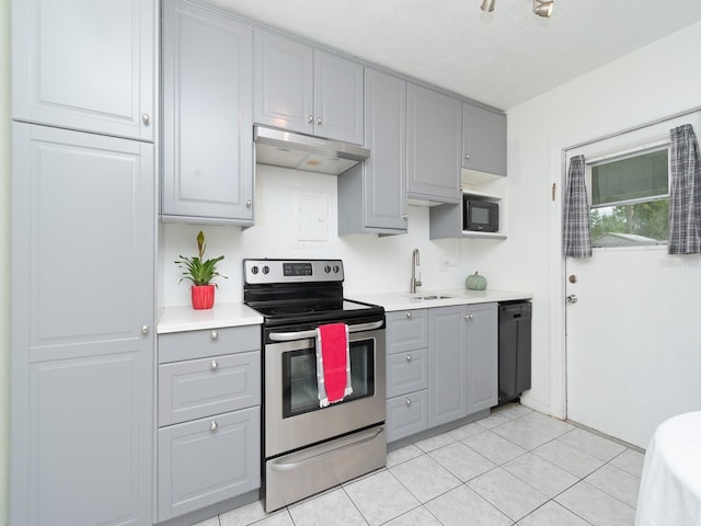 kitchen with sink, light tile patterned floors, stainless steel range with electric stovetop, gray cabinets, and black dishwasher