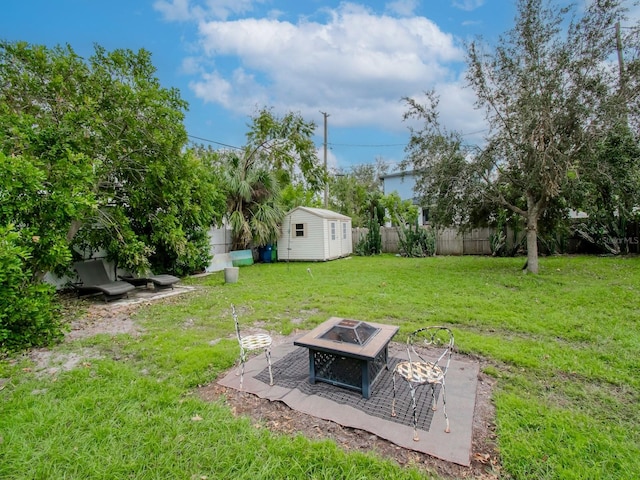 view of yard featuring a shed and a fire pit