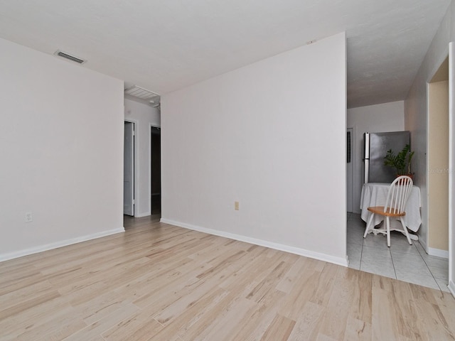 empty room with light hardwood / wood-style floors