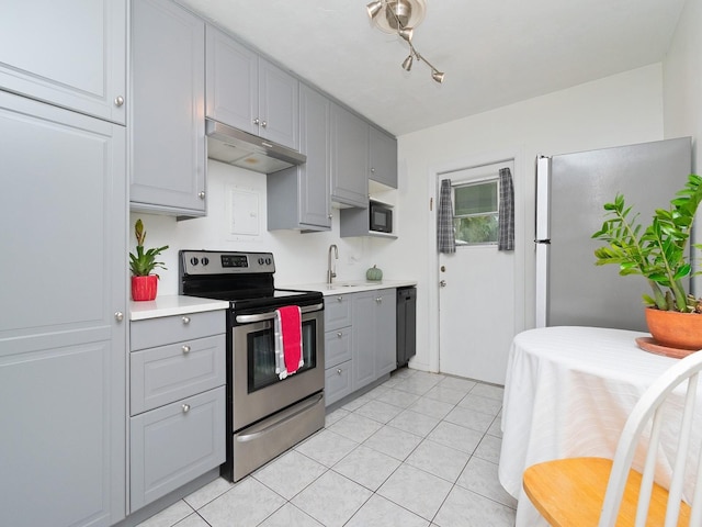 kitchen with gray cabinetry, appliances with stainless steel finishes, sink, and light tile patterned flooring