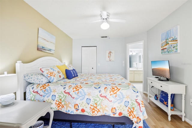 bedroom with a closet, ceiling fan, connected bathroom, and light wood-type flooring