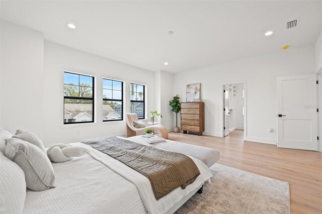 bedroom featuring light wood-type flooring, visible vents, and recessed lighting