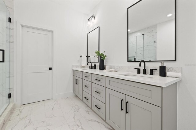 full bathroom featuring double vanity, marble finish floor, a marble finish shower, and a sink