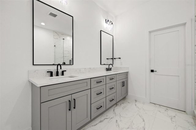 full bathroom featuring double vanity, a marble finish shower, visible vents, marble finish floor, and a sink