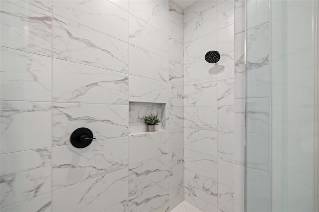 bathroom with a tile shower