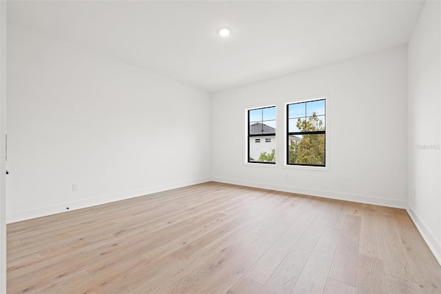 unfurnished room featuring light wood finished floors and baseboards