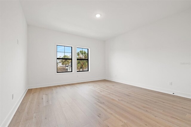 empty room with light wood-style flooring and baseboards