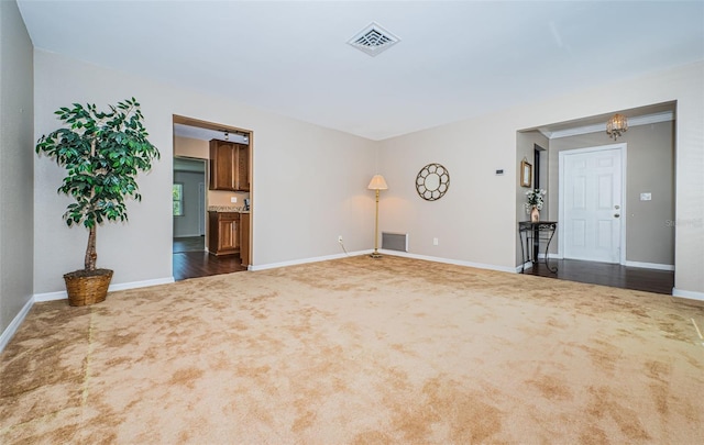 unfurnished living room featuring dark colored carpet