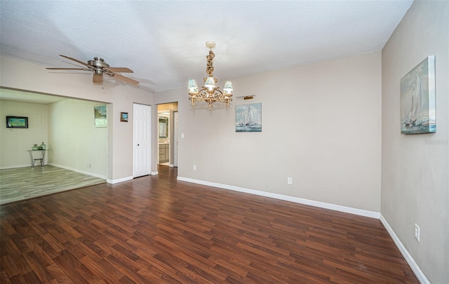 unfurnished room with ceiling fan with notable chandelier, a textured ceiling, and dark hardwood / wood-style floors