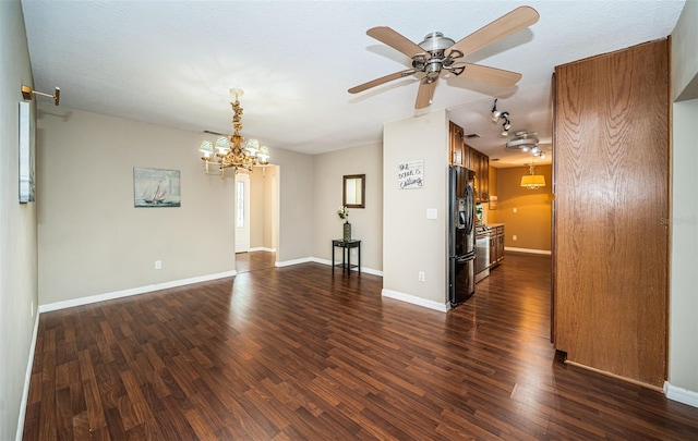 spare room featuring a textured ceiling, ceiling fan with notable chandelier, and dark hardwood / wood-style floors