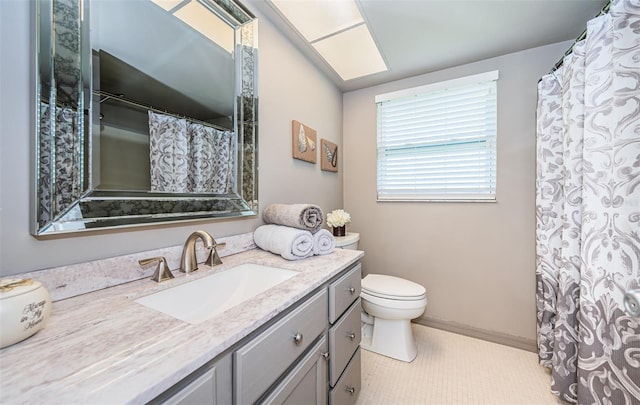 bathroom featuring tile patterned flooring, vanity, and toilet