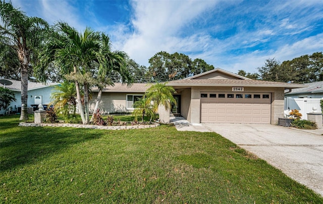 single story home featuring a garage and a front yard