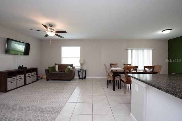 living room with ceiling fan and light tile patterned floors