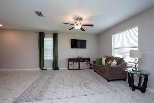 tiled living room with ceiling fan