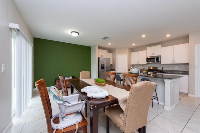 dining space featuring light tile patterned floors