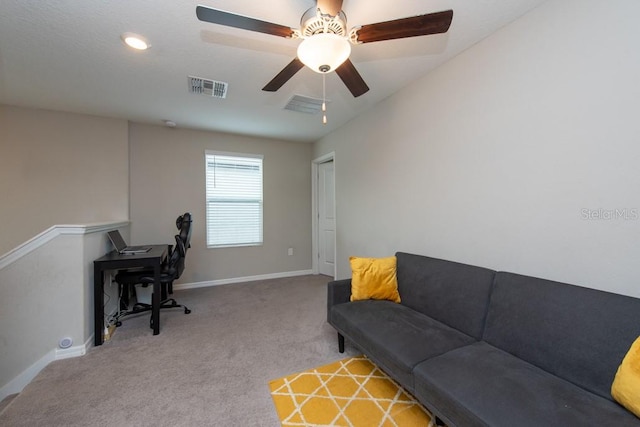 carpeted living room with ceiling fan