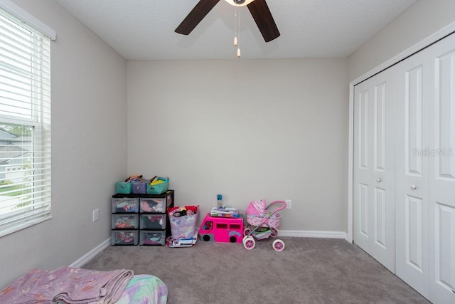 bedroom with a closet, ceiling fan, and light colored carpet