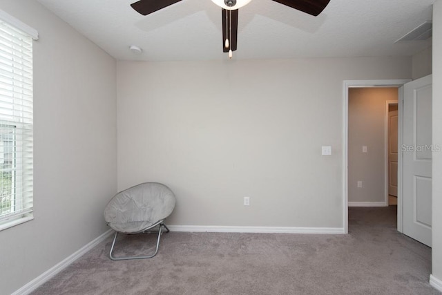 empty room with ceiling fan and light colored carpet