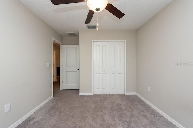 10348 Blue Plume Ct, Riverview, FL 33578 - unfurnished bedroom with carpet, a closet, baseboards, and a ceiling fan