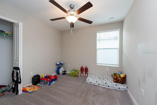 playroom featuring ceiling fan and carpet floors