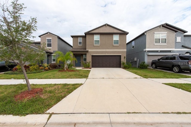 view of property with a garage and a front lawn