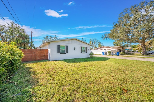 rear view of property with a yard and fence