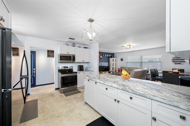 kitchen featuring decorative light fixtures, white cabinetry, a notable chandelier, light stone counters, and stainless steel appliances