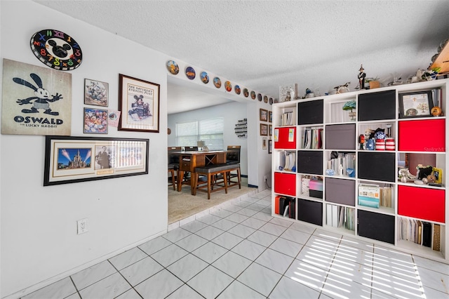 interior space with tile patterned floors and a textured ceiling