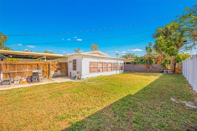 rear view of house featuring a yard