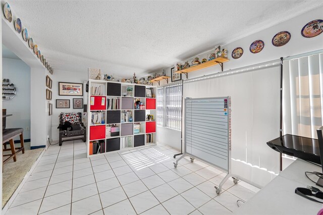 interior space featuring tile patterned flooring and a textured ceiling