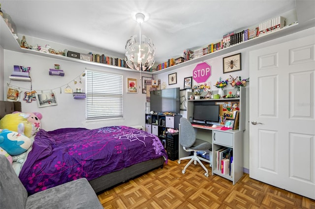 bedroom with an inviting chandelier and parquet flooring