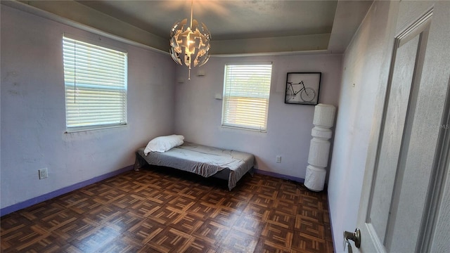 bedroom featuring baseboards and a chandelier