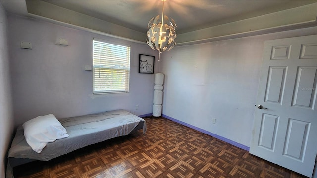 bedroom with a notable chandelier and baseboards