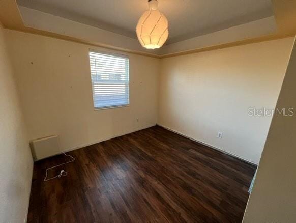 unfurnished room with visible vents and wood finished floors