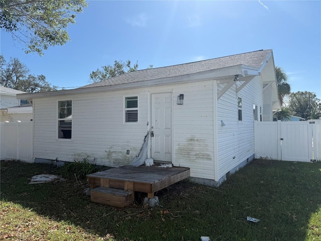 rear view of house with a lawn