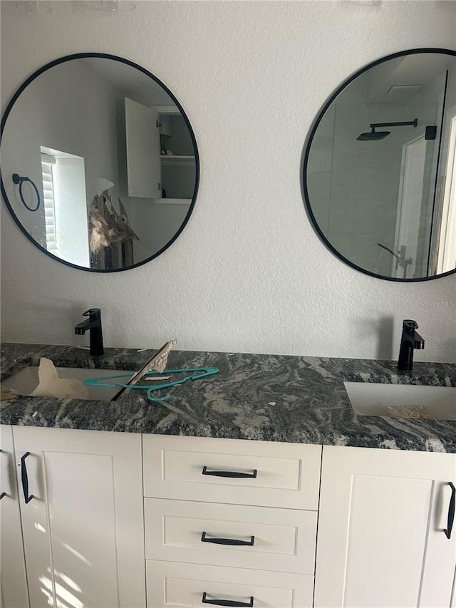 bathroom with vanity and a shower