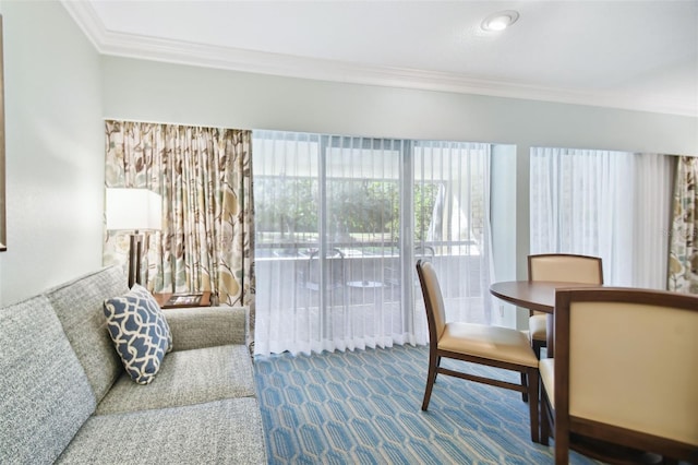 carpeted dining space with crown molding