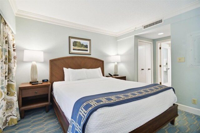 carpeted bedroom featuring a closet and ornamental molding