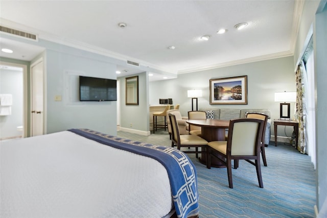 bedroom with ornamental molding and carpet