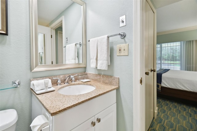 bathroom featuring vanity and toilet