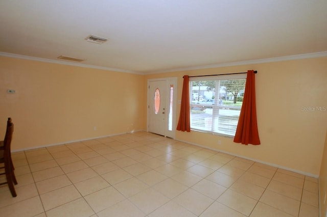 tiled foyer featuring ornamental molding