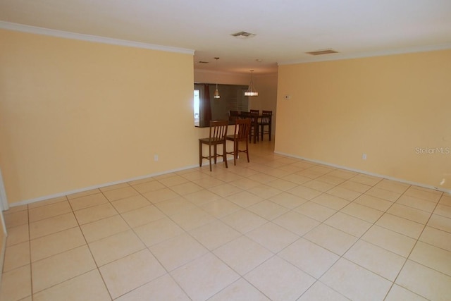 tiled spare room with crown molding