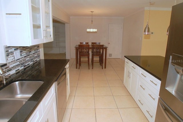 kitchen with sink, stainless steel appliances, crown molding, pendant lighting, and white cabinets