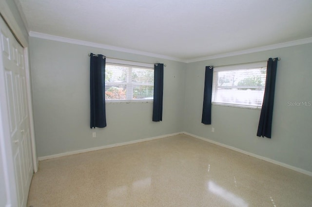 empty room with a healthy amount of sunlight and ornamental molding